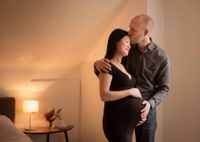 couple embracing on maternity shoot at home