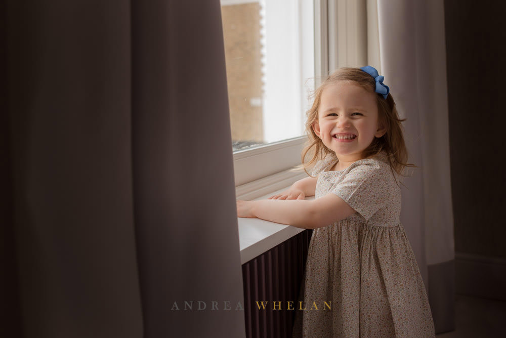 little girl by window 