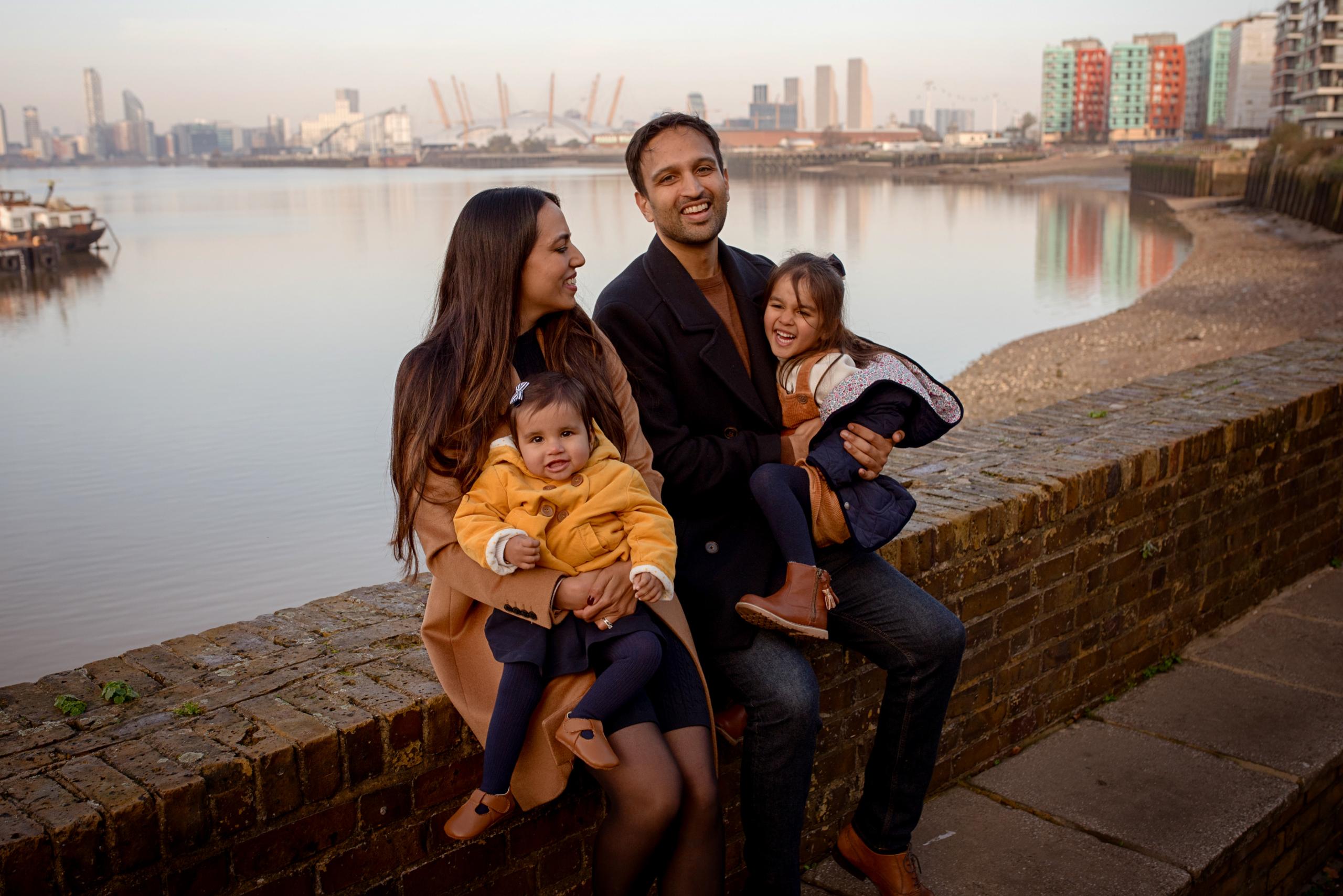 Riverside shot of local family smiling in greenwich